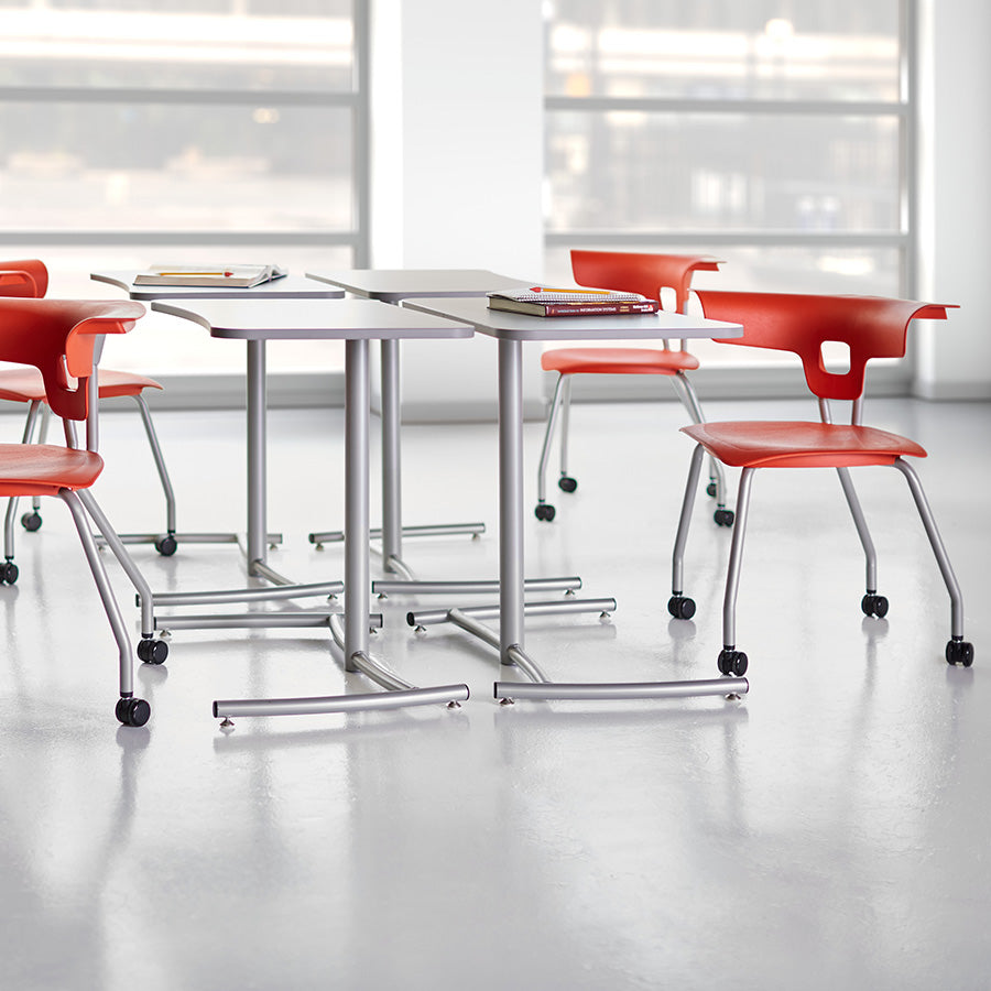 Ruckus 4 Leg Chair with castors starlight silver frame with poppy red seat and back lifestyle image 2