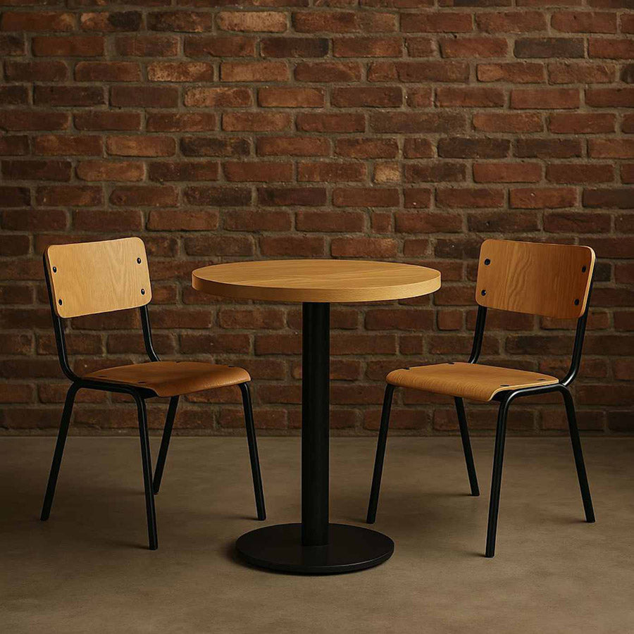Wooden table with two chairs against a brick wall