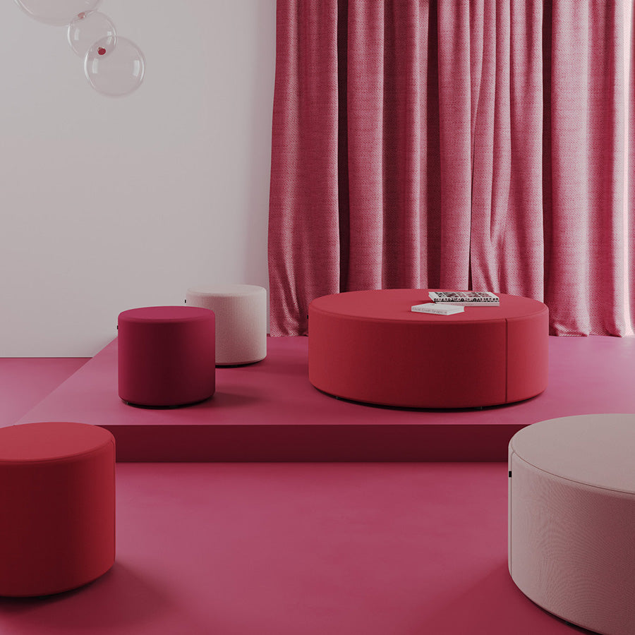 Modern red and pink Point Ottomans against a pink curtain.