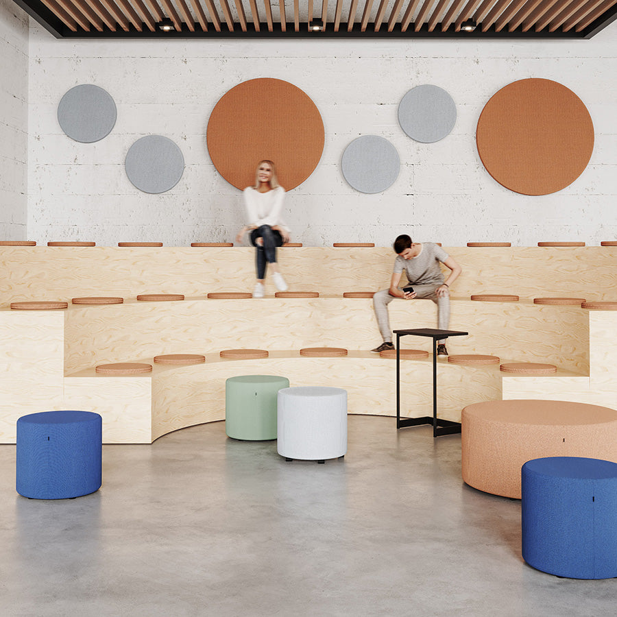Modern interior design with wooden benches, colourful Point ottomans or stools, and circular wall art.