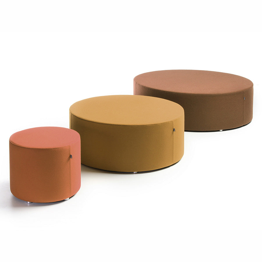 Three round fabric Point ottomans in different colours on a white background