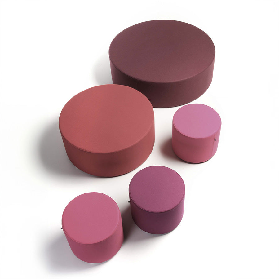 Set of pink cylindrical Point ottomans on a white background