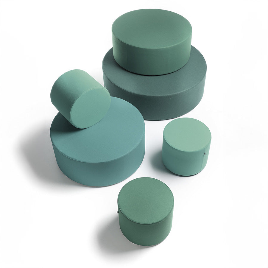 Set of green cylindrical Point ottomans on a white background