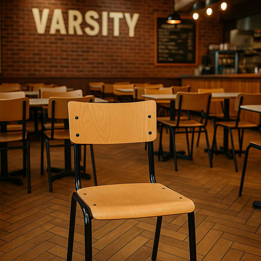 Chair in a restaurant with 'Varsity' sign on the wall
