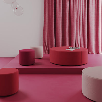 Modern red and pink Point Ottomans against a pink curtain.